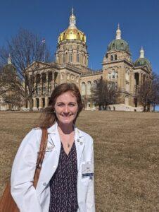 Claire Carmichael in front of the Iowa Capitol building.